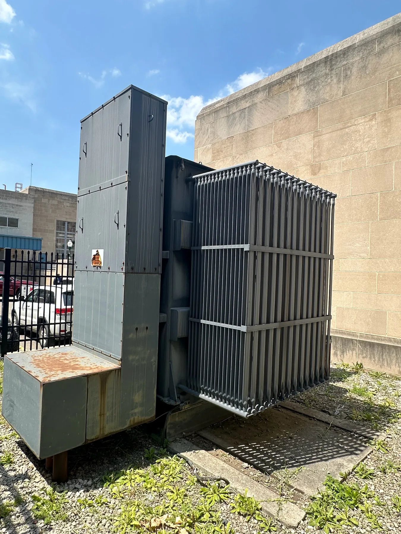 Large industrial substation transformer installed beside a commercial facility