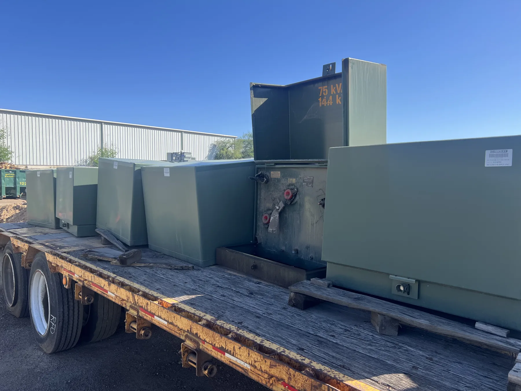 Padmount electrical transformers loaded on a flatbed trailer